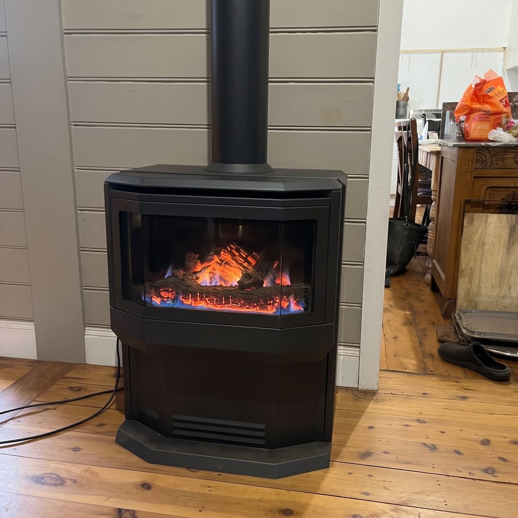 Freestanding gas log heater in a living room